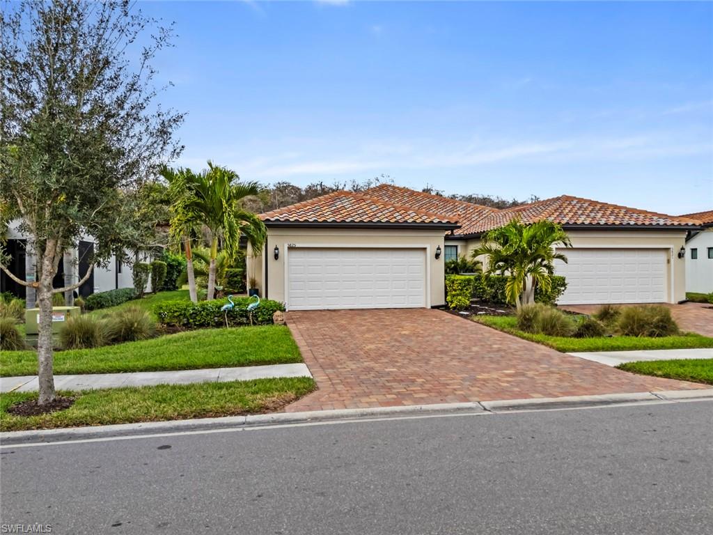 5825 Mayflower Way Ave Maria, FL 34142 - Photo 4 of 50 a front view of a house with a yard and a garage