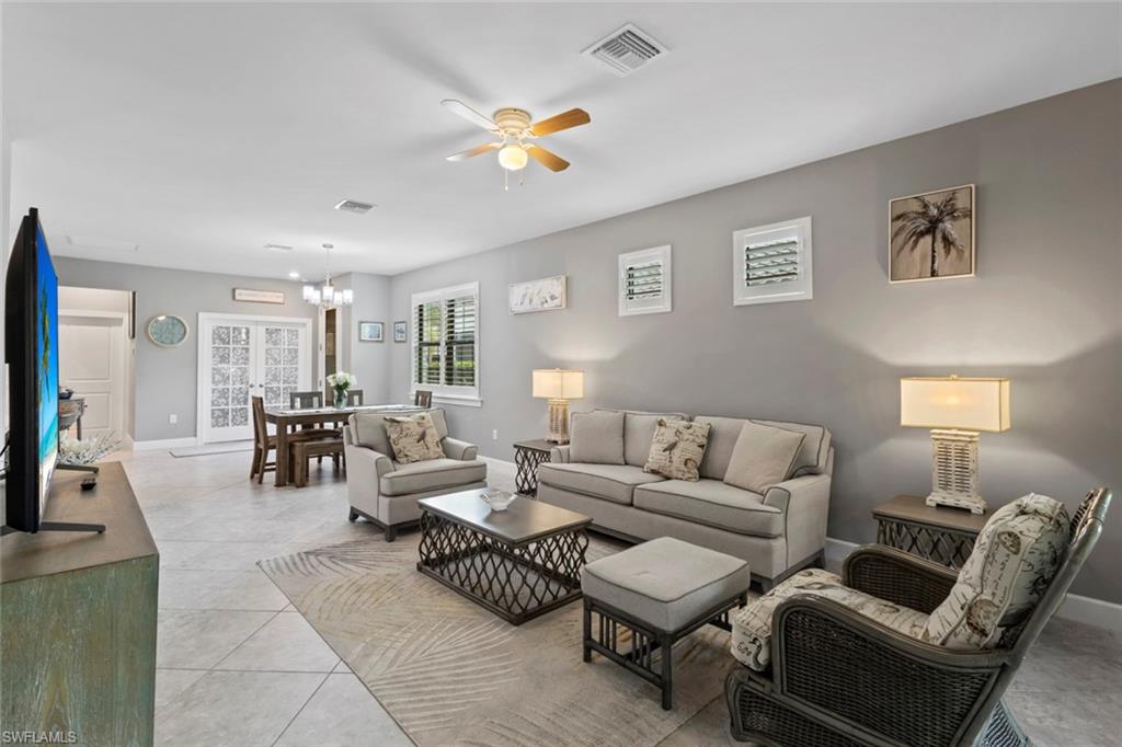 5825 Mayflower Way Ave Maria, FL 34142 - Photo 7 of 50 a living room with furniture and a lamp