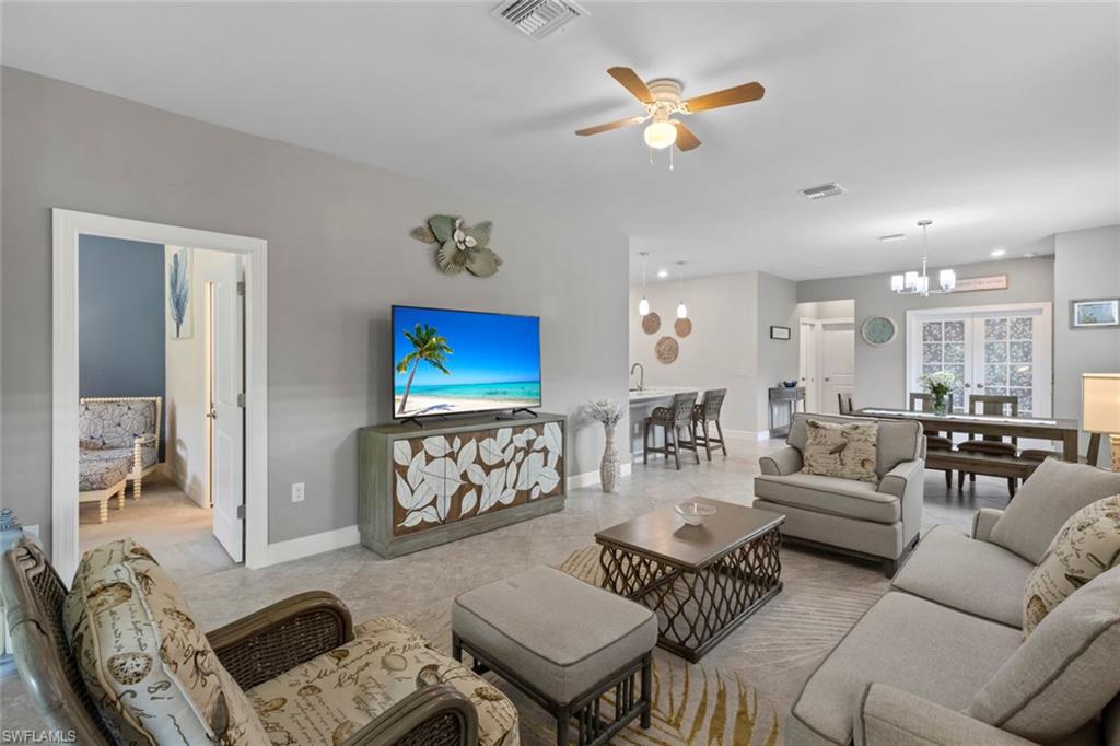 5825 Mayflower Way Ave Maria, FL 34142 - Photo 8 of 50 a living room with furniture a ceiling fan and a rug