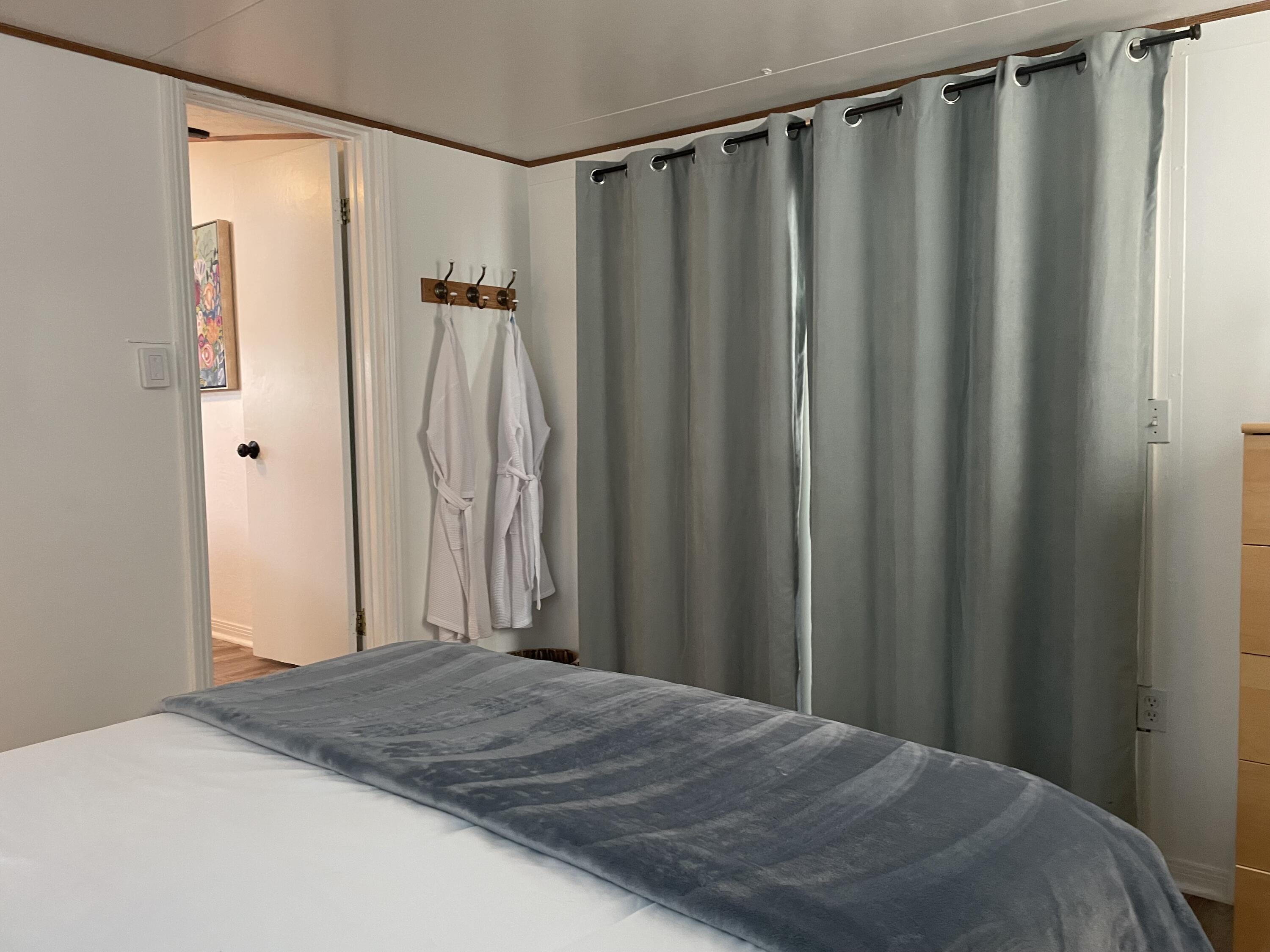 74711 Dillon Road, Unit 711 Desert Hot Springs, CA 92241 - Photo 11 of 35 a bedroom with a bed and a shower curtain