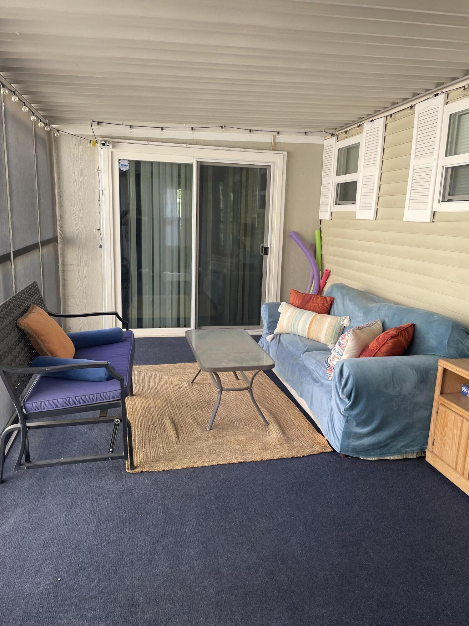 74711 Dillon Road, Unit 711 Desert Hot Springs, CA 92241 - Photo 13 of 35 a living room with furniture and a potted plant