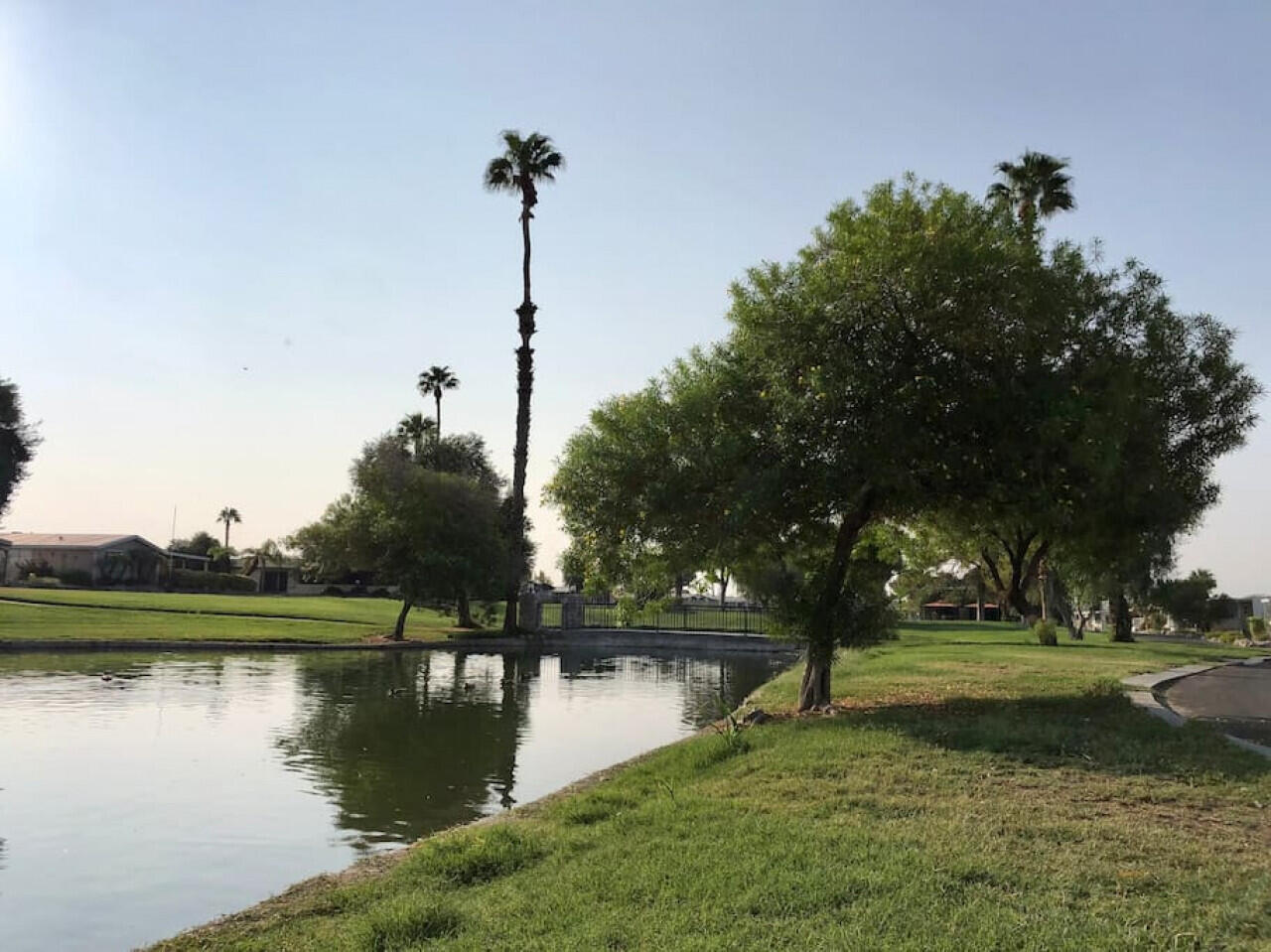 74711 Dillon Road, Unit 711 Desert Hot Springs, CA 92241 - Photo 33 of 35 a view of a lake with a house in the background
