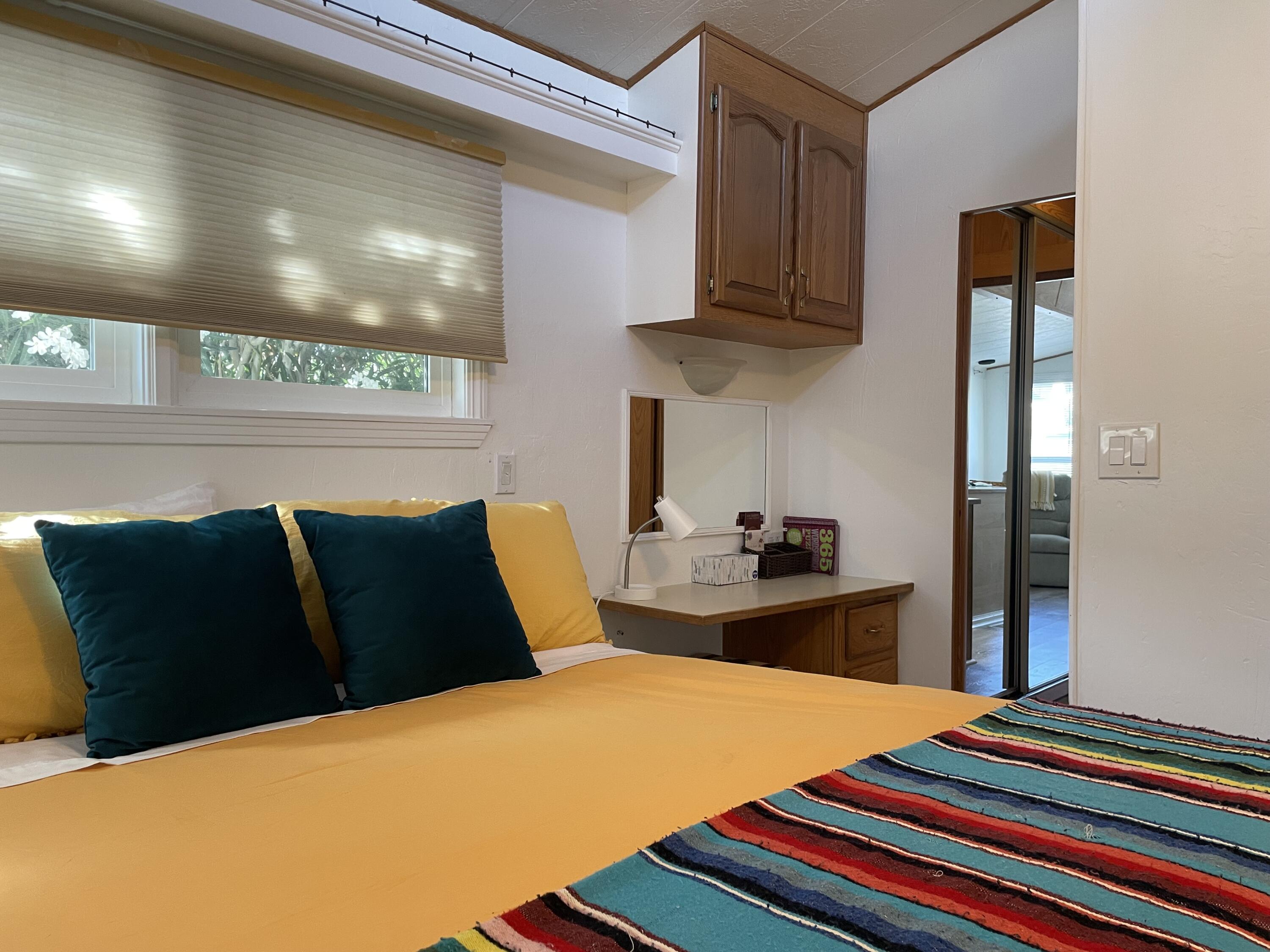 74711 Dillon Road, Unit 711 Desert Hot Springs, CA 92241 - Photo 8 of 35 a bedroom with a bed and dresser with mirror