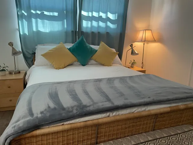 a bed sitting in a bedroom next to a lamp