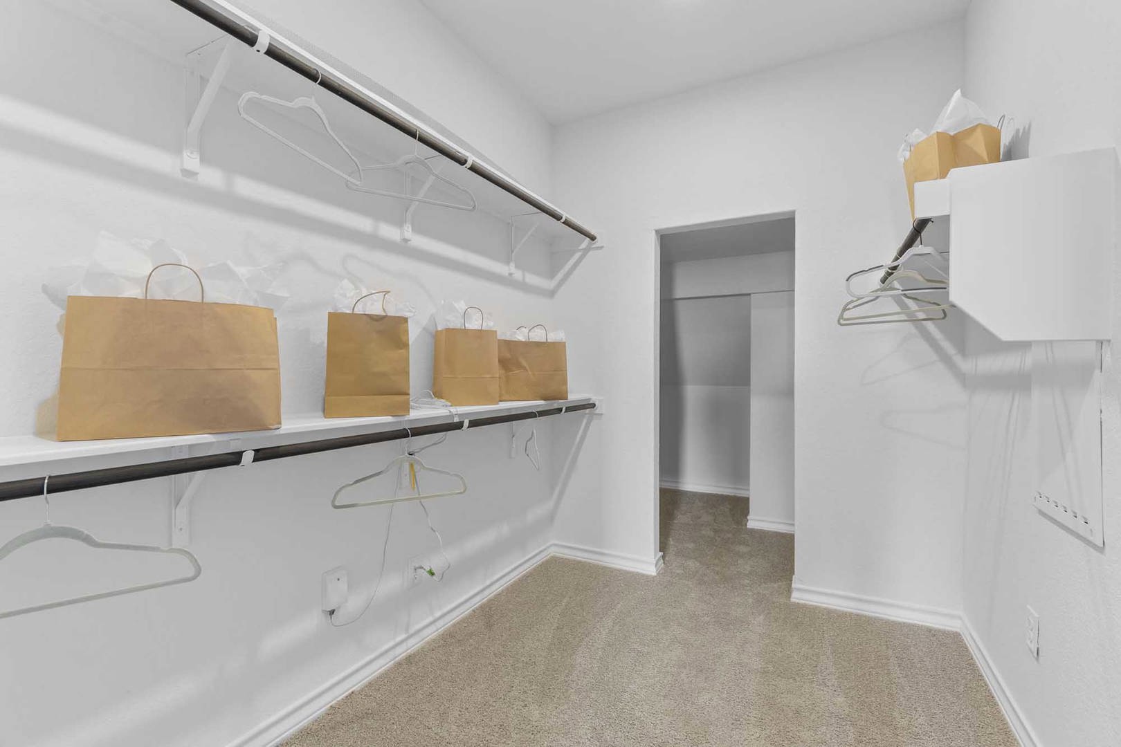105 Hatari Trail Jarrell, TX 76537 - Photo 15 of 27 Ample hanging rods and built-in shelving maximize storage space in this carpeted closet.