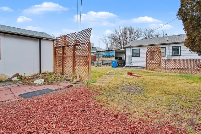 a view of a house with backyard and sitting area