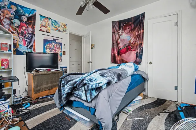 a bedroom with a bed and flat screen tv