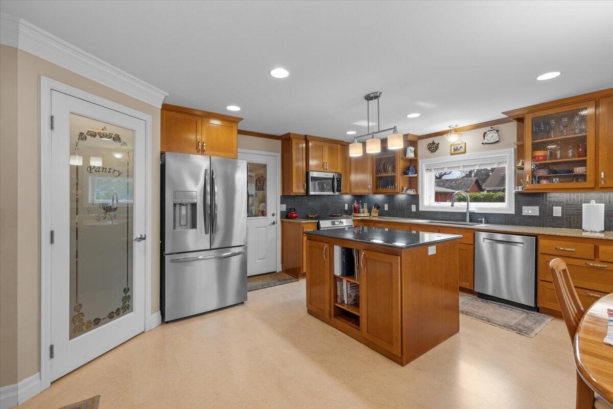 440 Bush Street Central Point, OR 97502 - Photo 16 of 40 a kitchen with stainless steel appliances granite countertop a refrigerator a sink and a stove