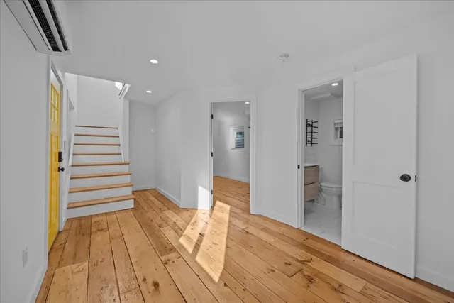 a view of a room with wooden floor and stairs