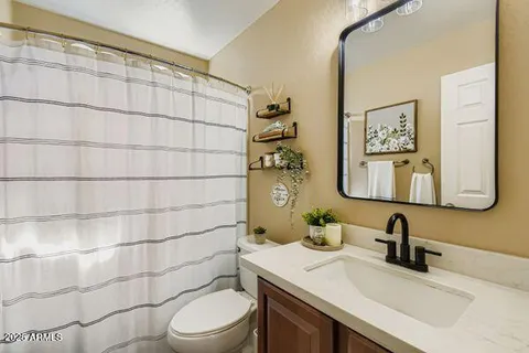 a spacious bedroom with a bed and a chandelier