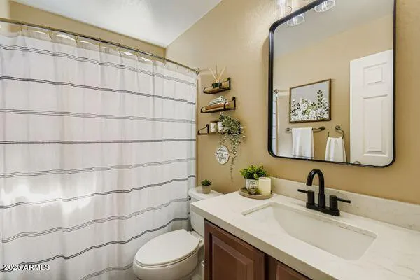 a spacious bedroom with a bed and a chandelier