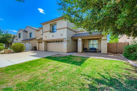 a view of a house with a yard and a patio