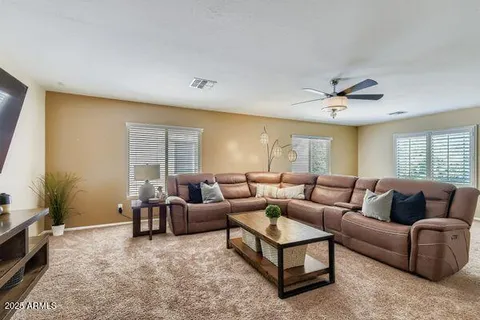 a view of a house with a yard and sitting area