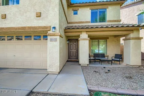 a living room with furniture and a dining table with wooden floor