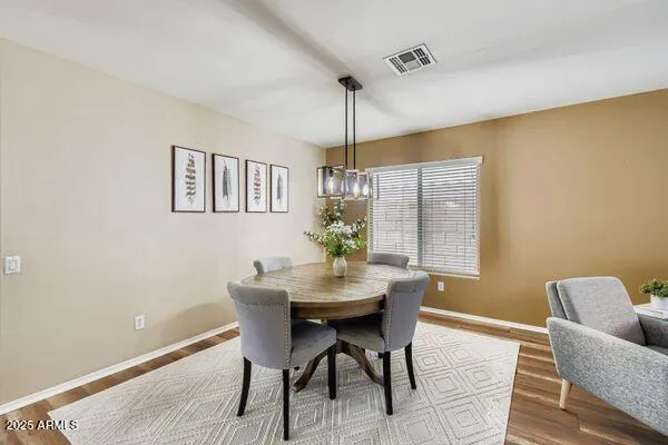 a kitchen with stainless steel appliances granite countertop refrigerator a sink dishwasher a stove top oven a refrigerator with white cabinets and wooden floor