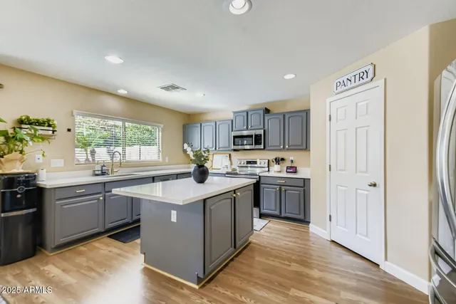 a kitchen with granite countertop a sink stove and refrigerator