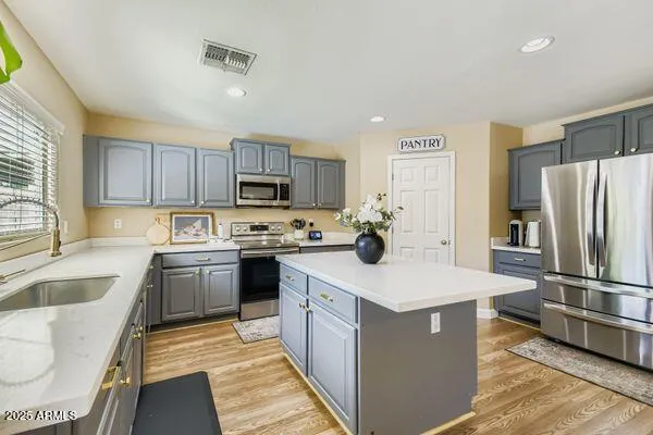 a kitchen with stainless steel appliances granite countertop a sink dishwasher stove and oven