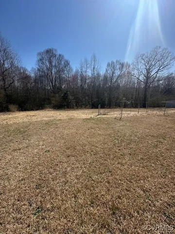 a view of a field with trees in the background
