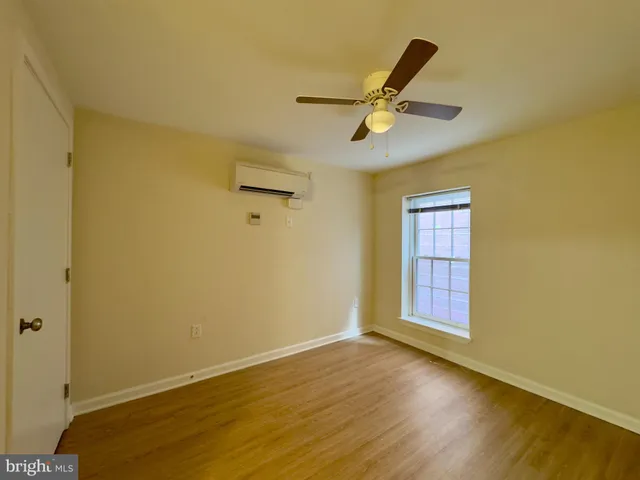 a view of a room with a wooden floor and a window