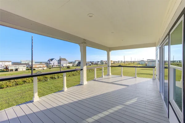 a view of a balcony with wooden floor