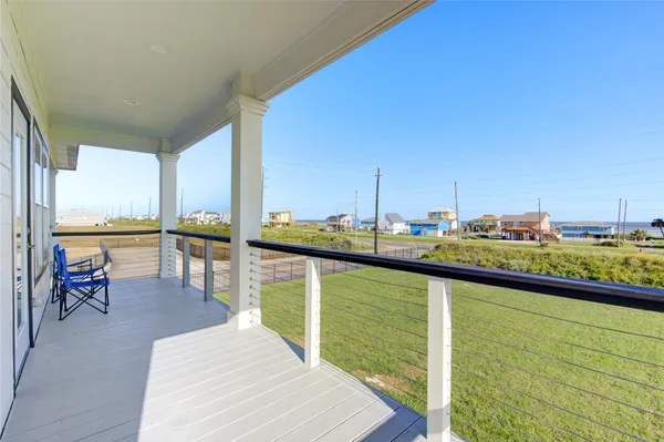 a view of a balcony with chairs