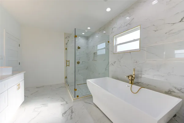 a white bath tub sitting in a bathroom
