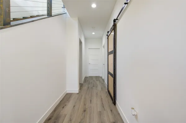 a view of hallway with wooden floor