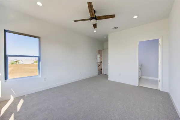 a view of an empty room and a window
