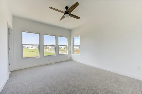 a view of a livingroom with a ceiling fan and window