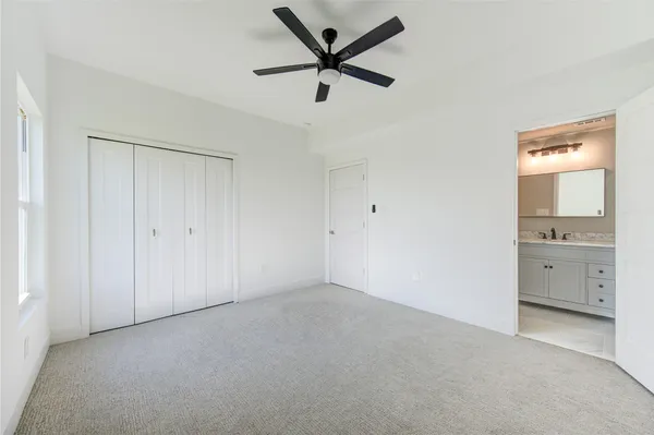 a view of an empty room and a ceiling fan