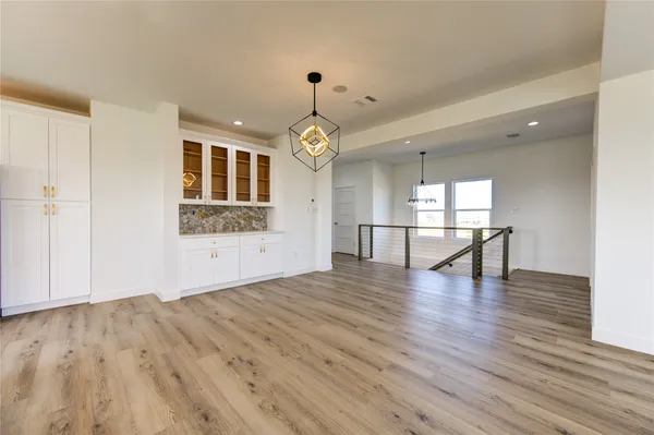 a view of an empty room window and wooden floor