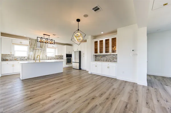 a view of kitchen with sink and wooden floor