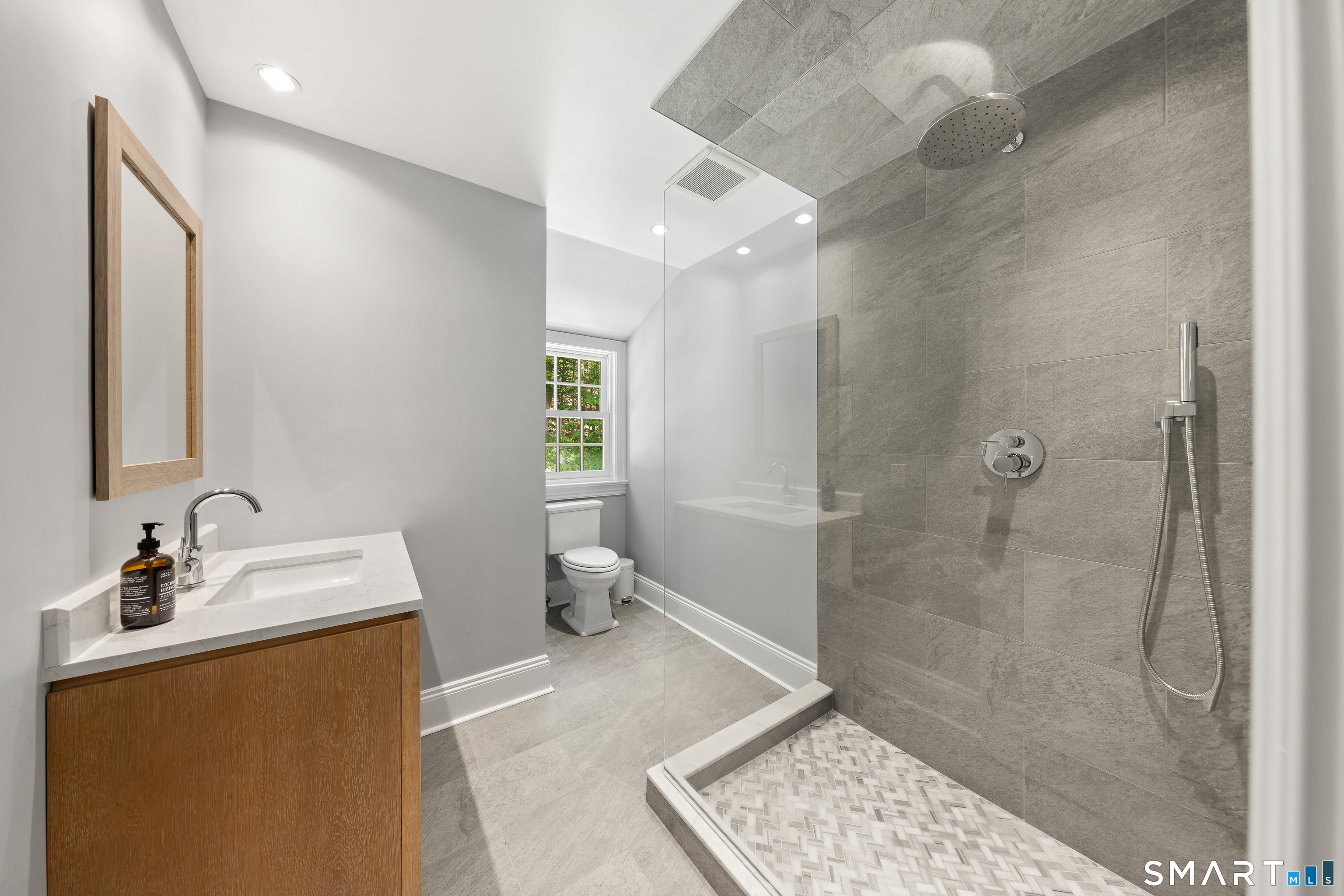 99 Hickok Road New Canaan, CT 06840 - Photo 25 of 39 a bathroom with a sink a toilet and shower