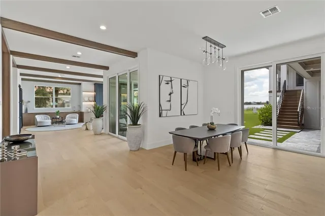 a living room with furniture a table and large windows
