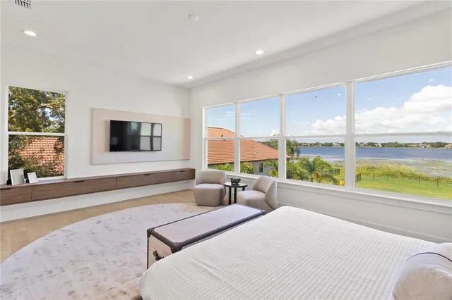 a bedroom with a large window and a bed