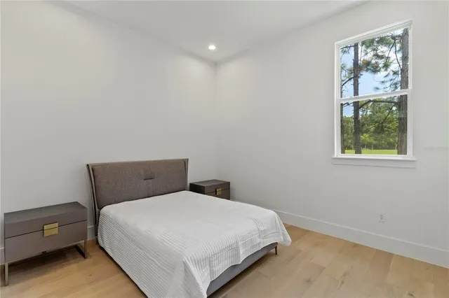 a bedroom with a bed and night stand