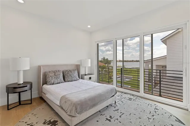 a bedroom with a large bed and a large window