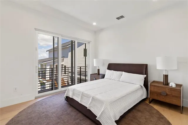 a bedroom with a large bed and a large window