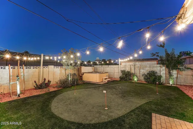 a view of a backyard with sitting area
