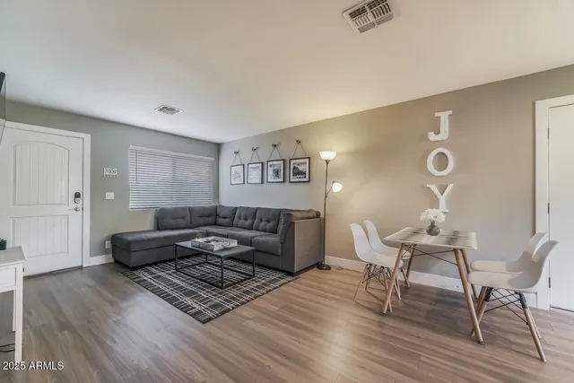 a living room with furniture and wooden floor