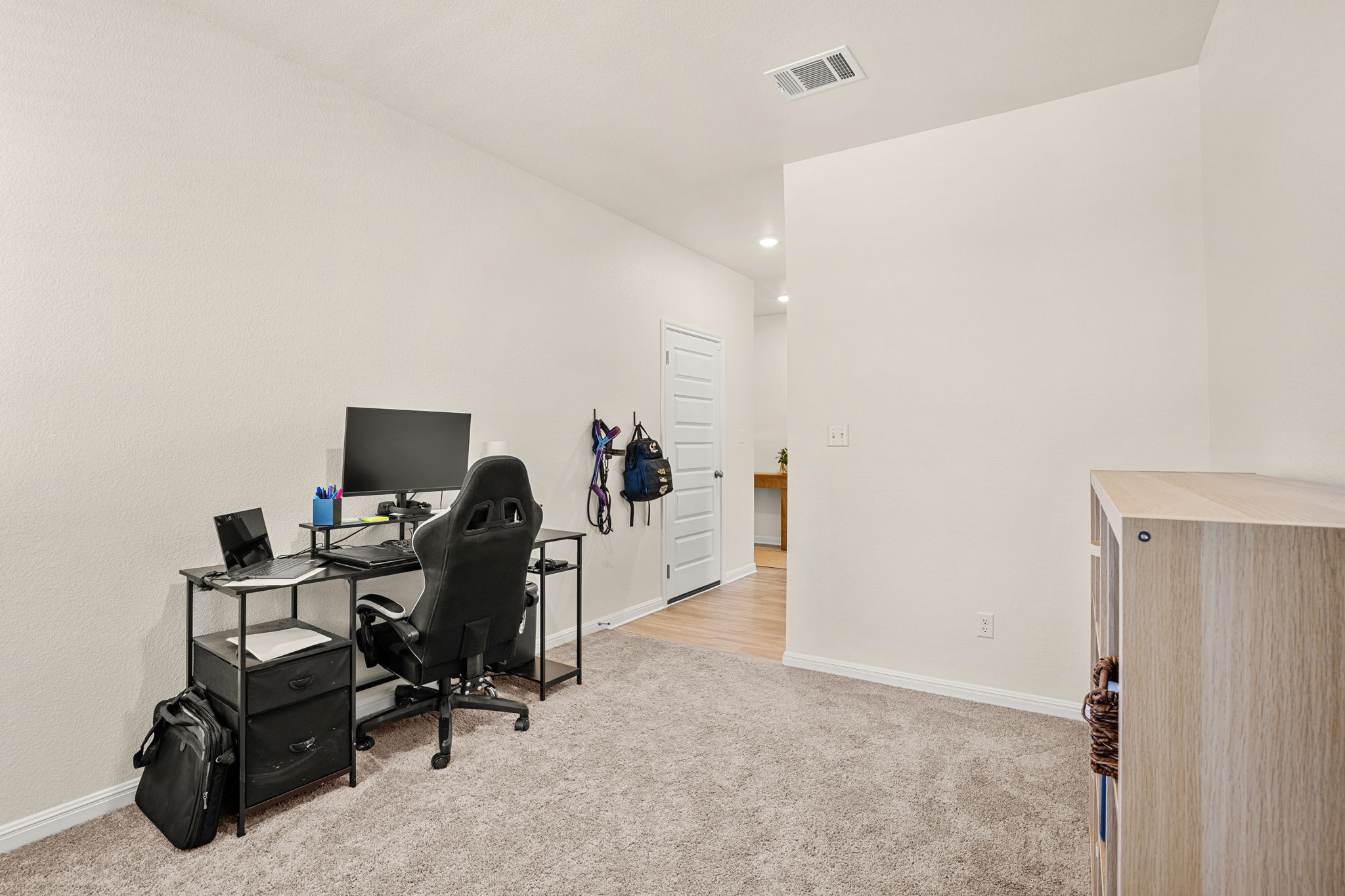 148 Hidalgo Lane Elgin, TX 78621 - Photo 19 of 38 An adaptable interior space featuring plush carpeting and a versatile layout.