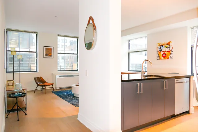 a kitchen with stainless steel appliances granite countertop a refrigerator and a stove