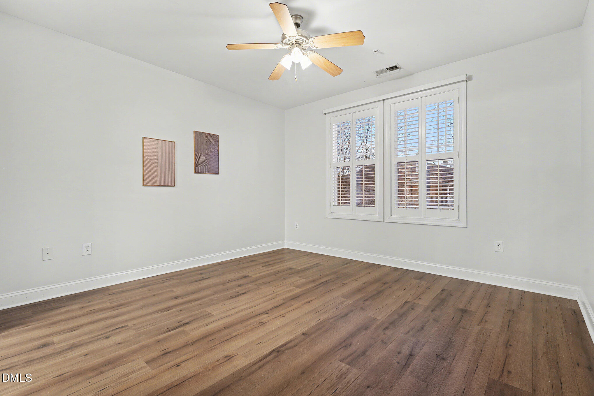 2810 Bedford Green Drive, Unit 207 Raleigh, NC 27604 - Photo 15 of 20 a view of empty room with wooden floor and fan