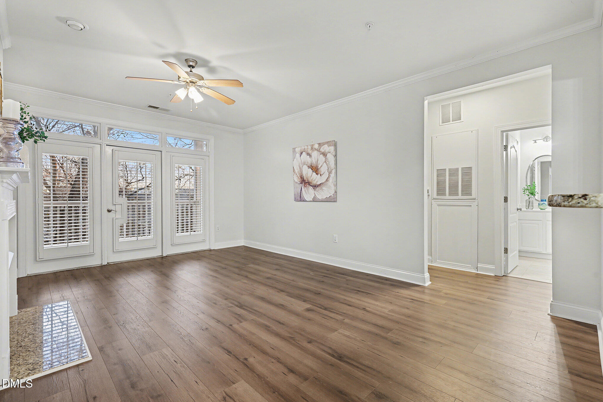 2810 Bedford Green Drive, Unit 207 Raleigh, NC 27604 - Photo 3 of 20 a view of an empty room with wooden floor and a window