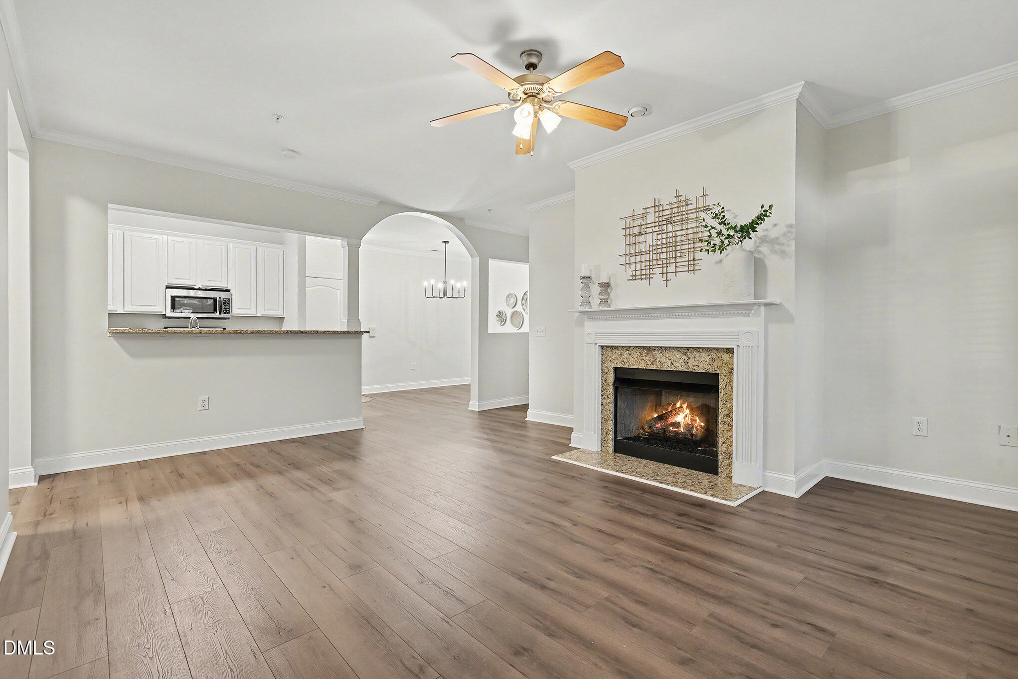 2810 Bedford Green Drive, Unit 207 Raleigh, NC 27604 - Photo 5 of 20 a view of a kitchen with wooden floor and a fireplace