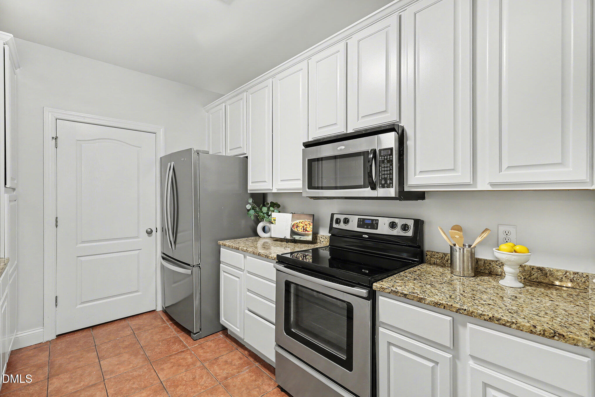 2810 Bedford Green Drive, Unit 207 Raleigh, NC 27604 - Photo 8 of 20 a kitchen with appliances a microwave and cabinets