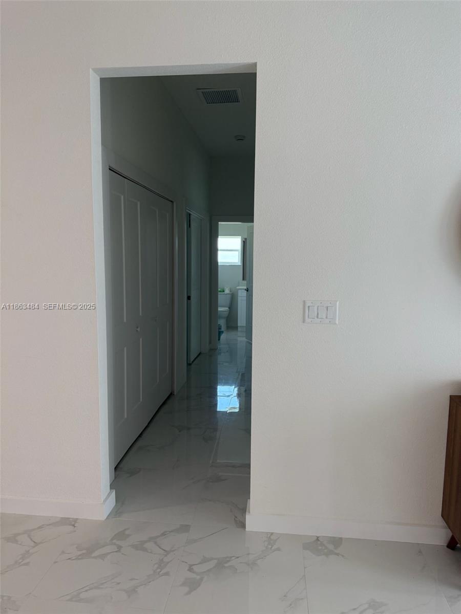 63 Coxswain Circle, Unit 63 Placida, FL 33946 - Photo 11 of 12 a view of a hallway with wooden shelves