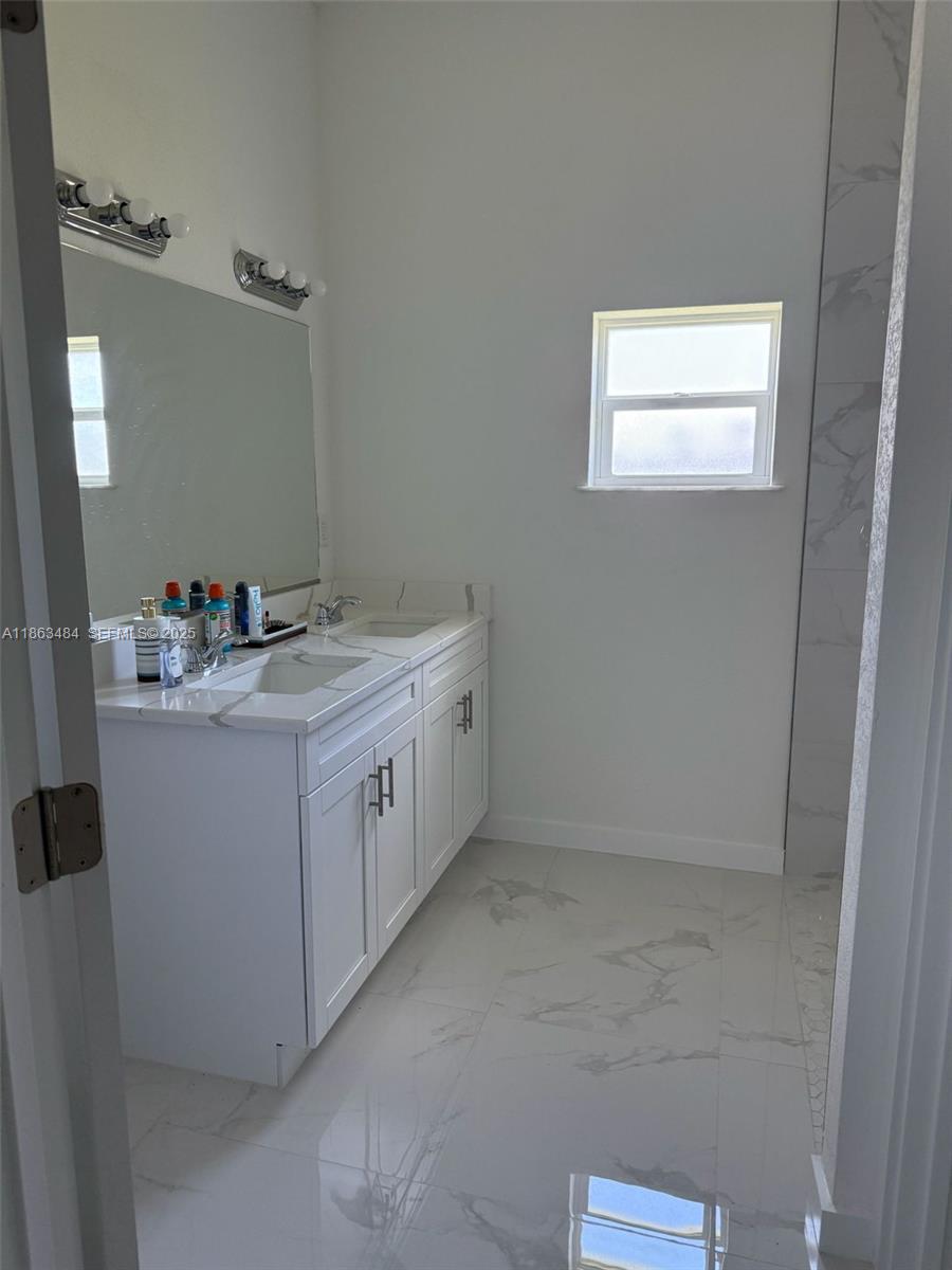 63 Coxswain Circle, Unit 63 Placida, FL 33946 - Photo 8 of 12 a utility room with cabinets washer and dryer