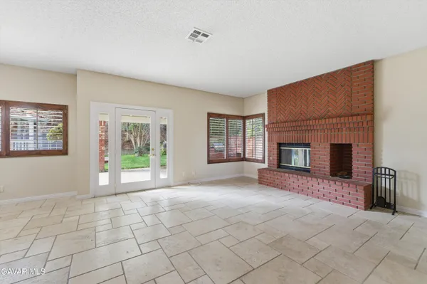 a view of a livingroom with an empty space and a fireplace