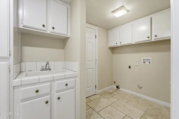 a view of a kitchen with white cabinets